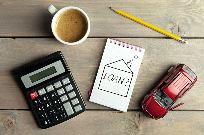 Home loan, calculator and coffee on  a table