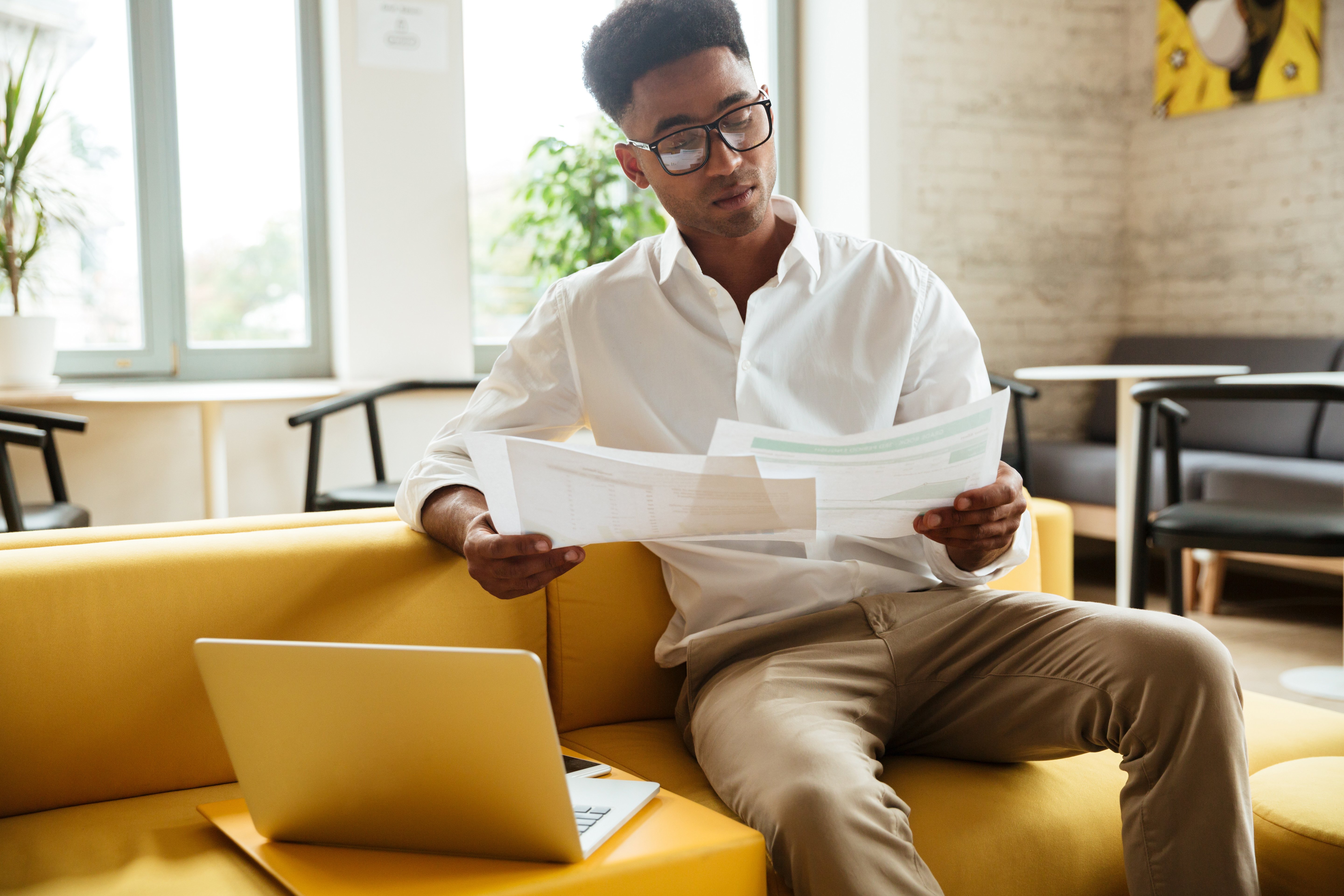 concentrated-young-african-man-sitting-coworking