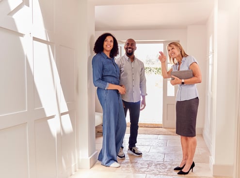 couple-viewing-potential-new-home-with-female-real-estate-agent