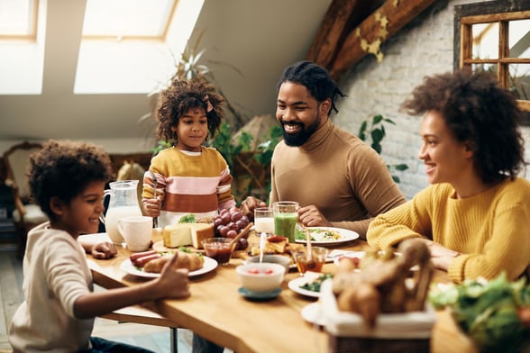 happy-black-family-enjoying-meal-dining-table-home