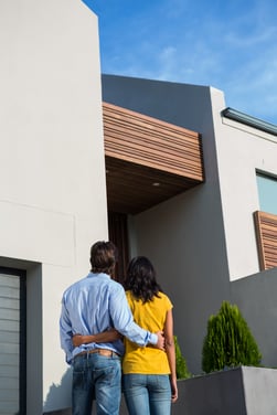 happy-couple-standing-looking-new-house